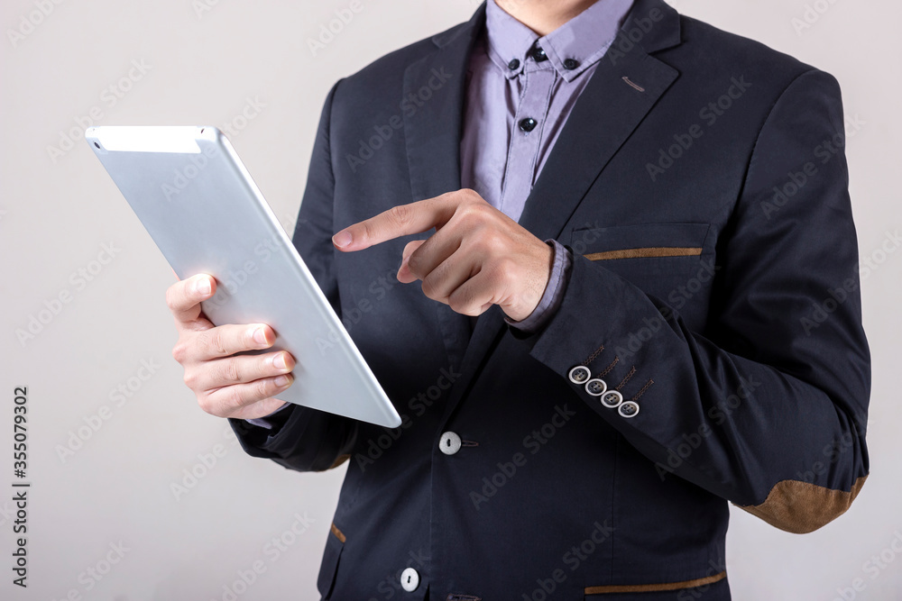 Man in business suit with digital composite using tablet. Man in business suit with digital composite using tablet.