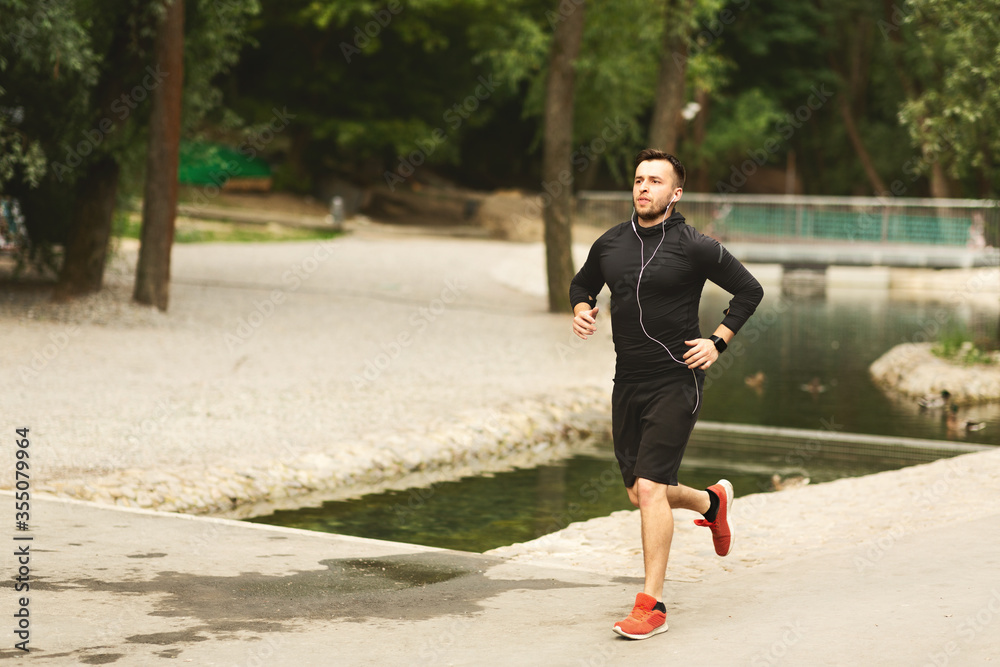Portrait of jogging guy running in the parkland Portrait of jogging guy running in the parkland