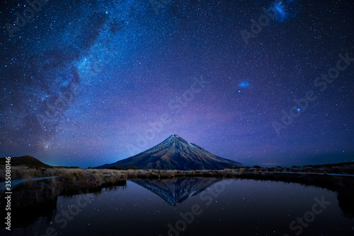 Night sky over Mt. Taranaki reflecting in Pouakai Pool, New Zealand