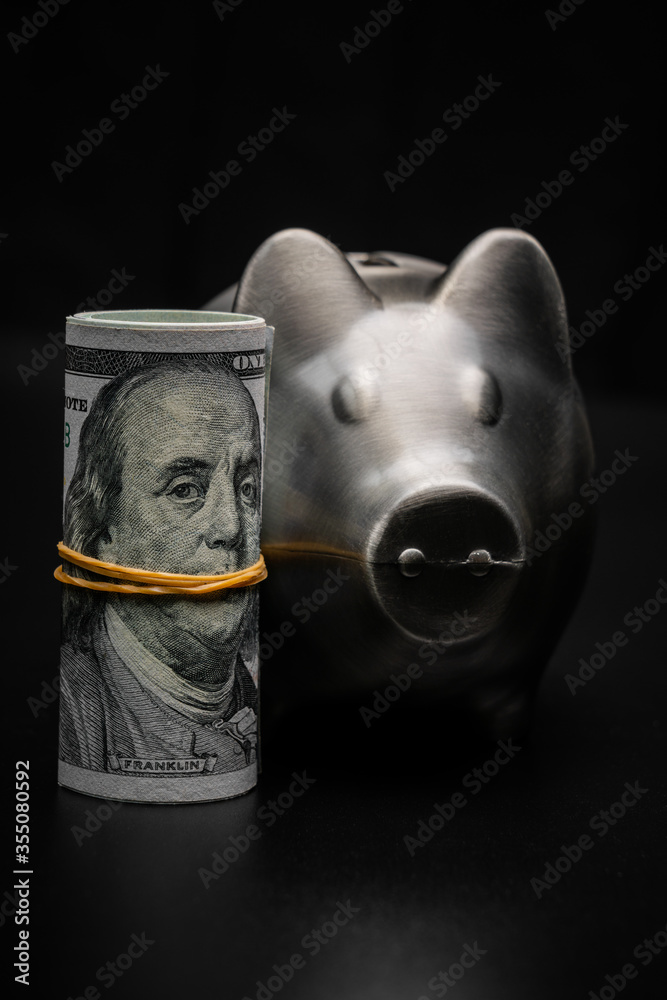 piggy bank with a roll us dollar - obrazy, fototapety, plakaty 