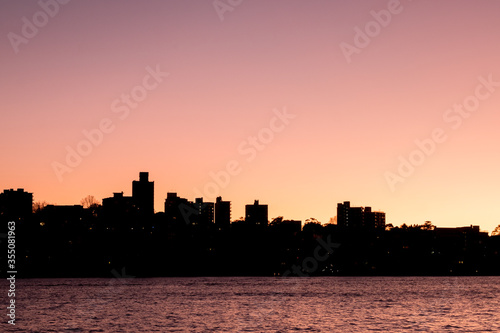 apartments by sydney harbour in dawn silhouette