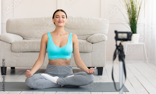 Fitness Blogger Girl Meditating Making Video For Blog At Home