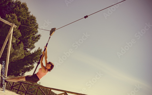 Adult woman having fun on zipline photo