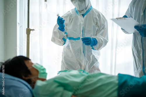 Asian doctor holding checking coronavirus or covid-19 infected patient name list sheet in quarantine area in hospital. Corona virus, Covid 19 virus outbreak, medical mask or virus outbreak concept