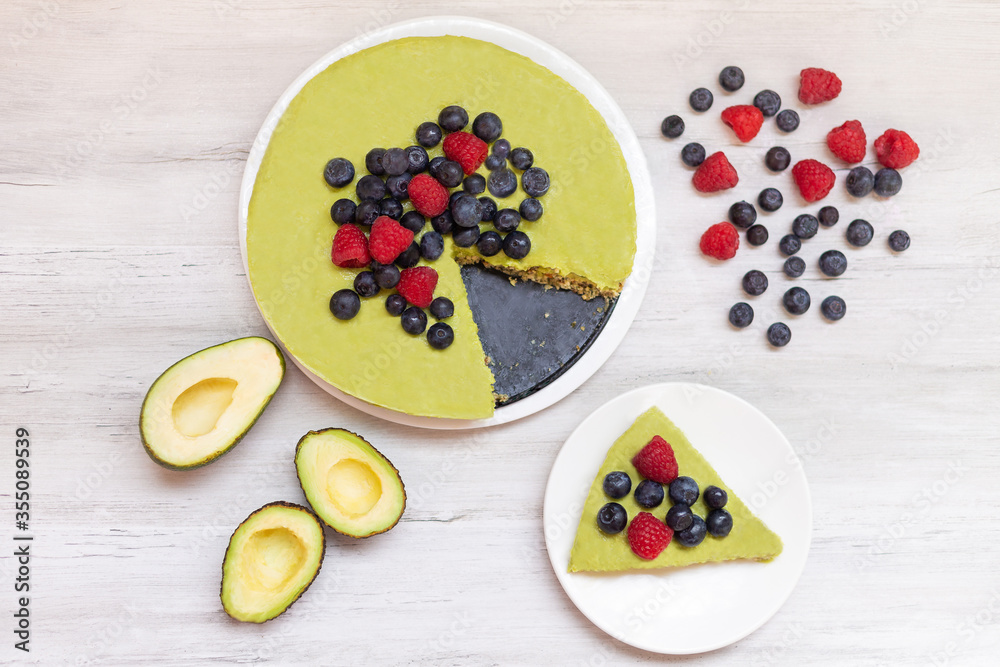 Tasty homemade avocado and lime Raw Cake with blueberries and raspberries, healthy vegan recipes Tasty homemade avocado and lime Raw Cake with blueberries and raspberries, healthy vegan recipes