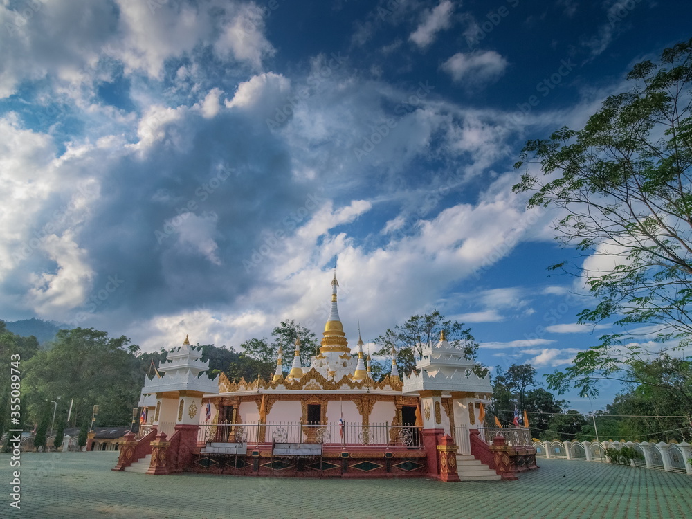 Fototapeta premium view of white pagoda with cloudy sky background, Mara Chena Chedi, Wat Fa Weangin, side by side Lak Tang border Pass, Wiang Hang District, Chiang Mai, northern of Thailand..