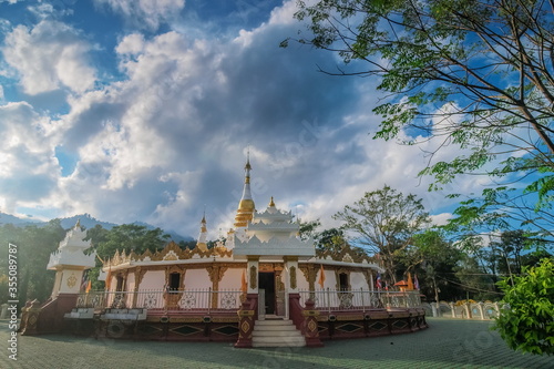 view of white pagoda with cloudy sky background, Mara Chena Chedi, Wat Fa Weangin, side by side Lak Tang border Pass, Wiang Hang District, Chiang Mai, northern of Thailand.. photo