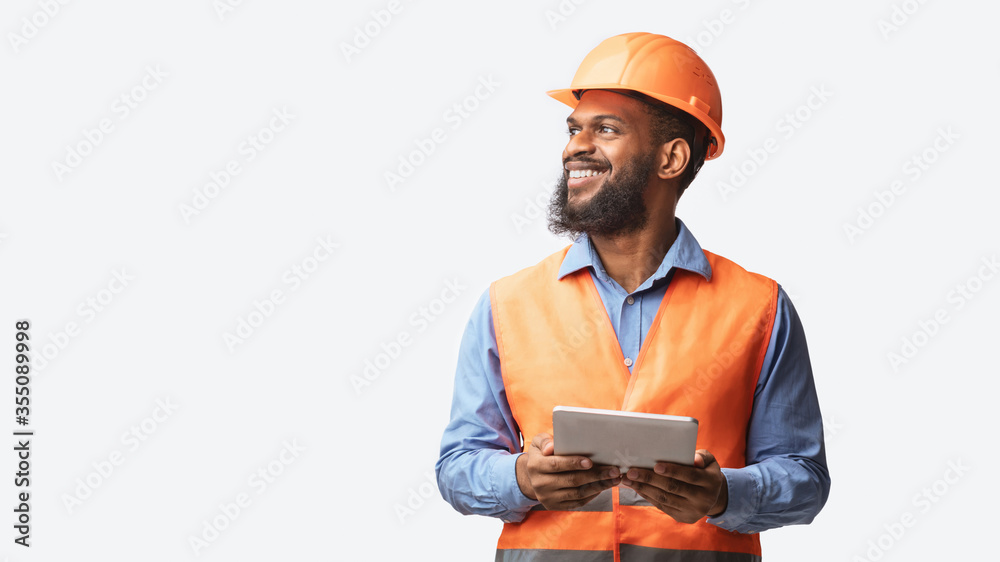 © Prostock-studio - Cheerful Builder Holding Digital Tablet Posing On White Studio Background © Prostock-studio - Cheerful Builder Holding Digital Tablet Posing On White Studio Background