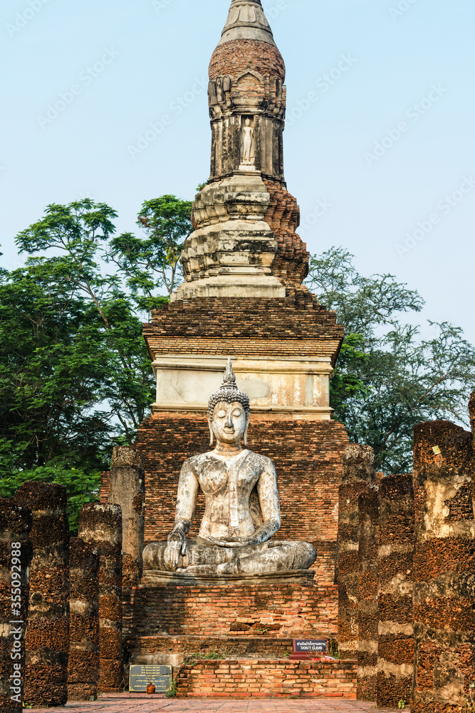 Old Buddhist temple Wat Traphang Ngoen with a sitting Buddha statue, ancient ruin city Sukhothai, Thailand