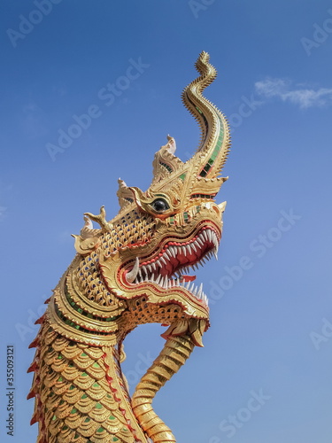 Close-up Naga (Dragon) statue with blue sky background, Wat Nam Tok Mae Klang, Chiang Mai, northern of Thailand.