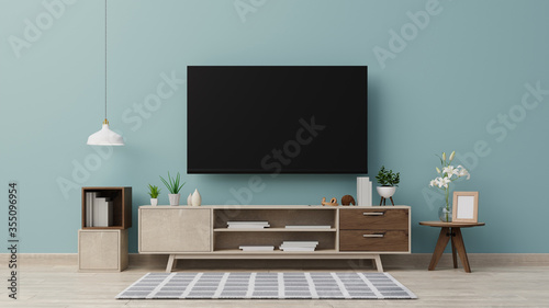 Interior mock up. TV on the cabinet in modern living room on blue wall background, 3d rendering © pramote