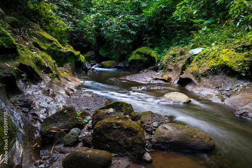 Tropical landscape. River with stones in rainforest. Soft focus. Slow shutter speed, motion photography. Nature background. Environment concept. Bangli, Bali, Indonesia