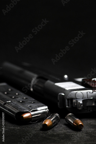 Automatic white gun stainless steel pistol weapon model m1911 with real bullet ammo in magazine with black background photo