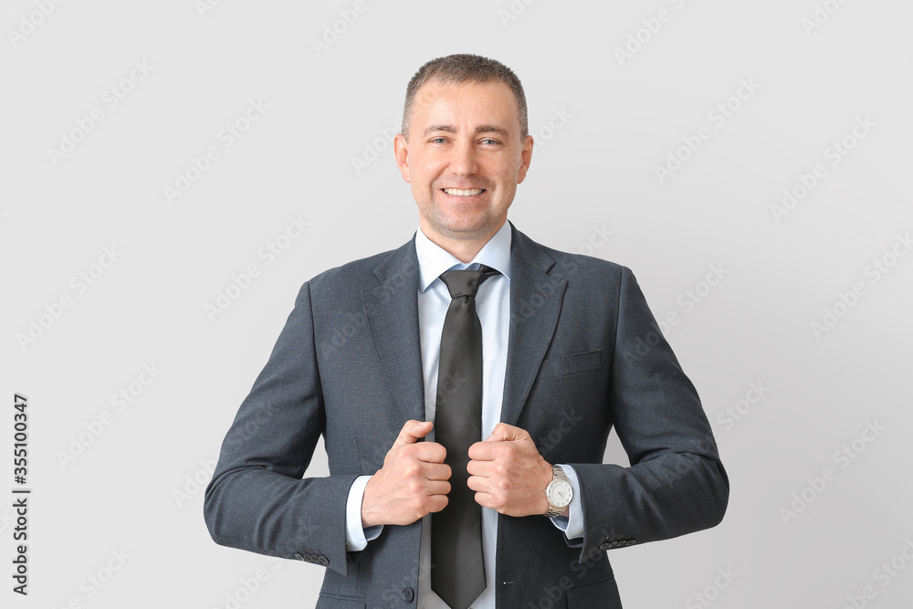 Portrait of handsome businessman on grey background Portrait of handsome businessman on grey background