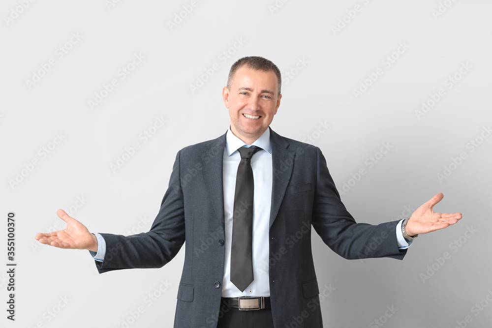 Portrait of handsome businessman on grey background Portrait of handsome businessman on grey background