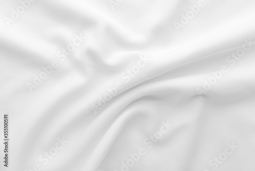 White abstract folded clothes background, fabric texture