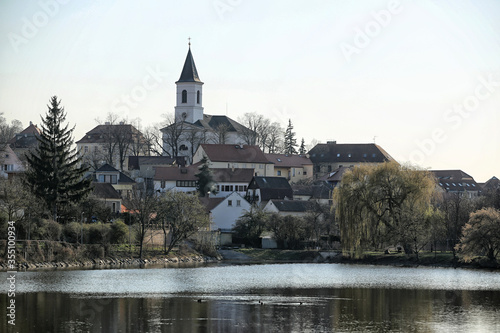 Village of Liboc with single church and houses by large pond