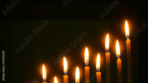 Black background candles Concept of life time remaining beautiful fire of a candle in a dark room, a warm yellow candle quietly burning in the dark, a candle burning in the dark.