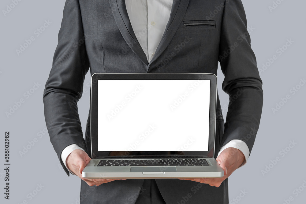 Businessman holding a computer and displaying the screen Businessman holding a computer and displaying the screen