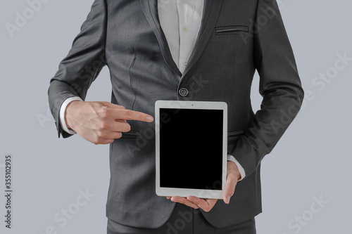Businessman hand holding tablet with blank on screen display