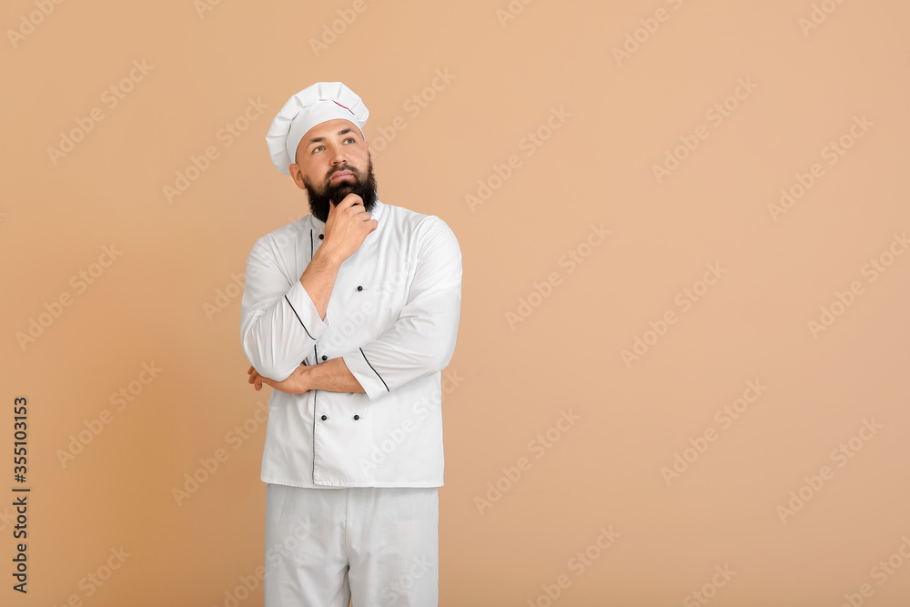Handsome thoughtful male chef on color background Handsome thoughtful male chef on color background
