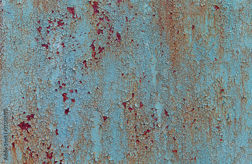 Blue cracked painted peeling textured aged rusty background.