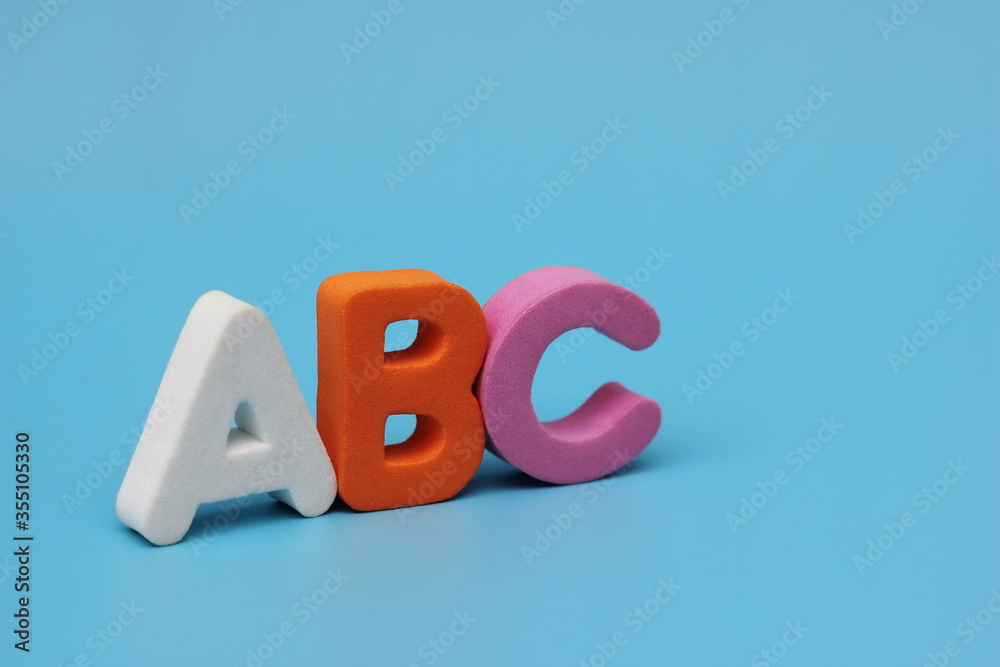 THE color letters of the ABC are isolated on a blue background. English alphabet. THE color letters of the ABC are isolated on a blue background. English alphabet.