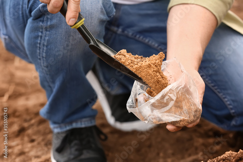 Man testing rich soil outdoors