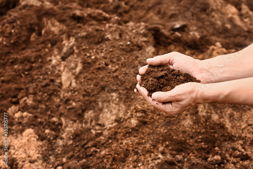 Man testing rich soil outdoors