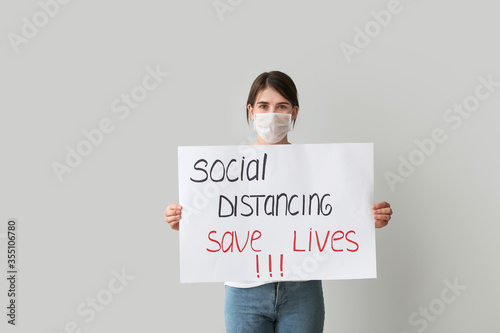 Young woman holding paper w...