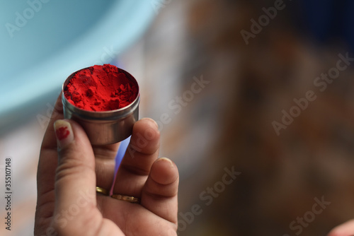 indian traditional sindoor (vermilion) box in a girl hand with shallow depth of field, Indian Culture