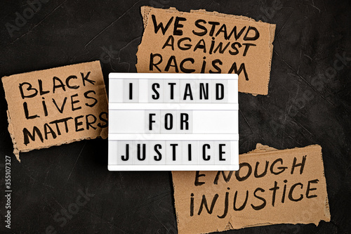 I stand for justice text on light box and other anti racism slogans photo