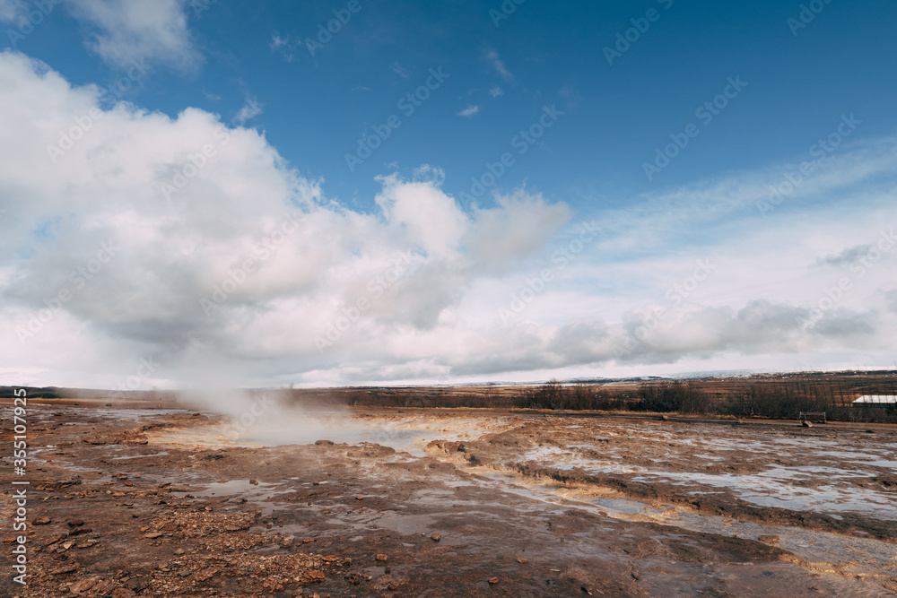 Geyser Valley in the southwest of Iceland. The famous tourist attraction Geysir. Geothermal zone Haukadalur. Strokkur geyser on the slopes of Laugarfjall hill.