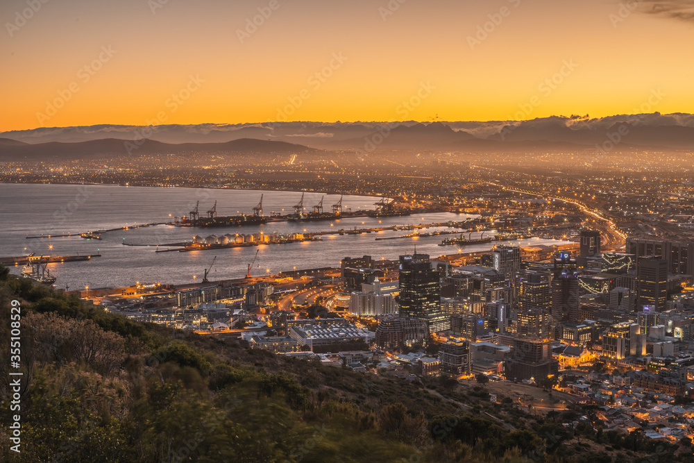 sunset in Cape town - capital of South Africa.Table mountain. view from above. harbor in the city. daylight. industrial landscape. high quality photo. night city