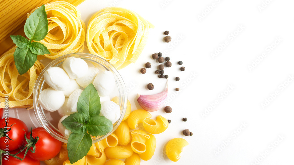 food on a white background pasta, spaghetti, garlic, mozzarella, tomatoes, pepper. Vegan salad.