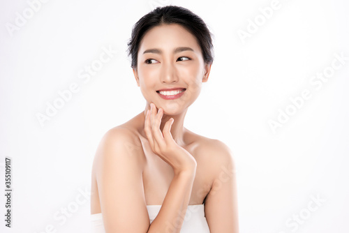 Portrait of a beautiful happy woman with a beautiful smile, clean and healthy skin and nude makeup on a white background. Cosmetology skin care and makeup