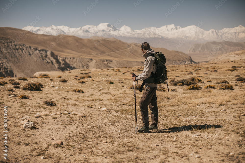 Upper mustang - Kingdom of Lo. Trekking in ancient Tibet. Sandstone massif in Nepal. high quality photo. Anapurna area. wild place.close territory. man backpacker in the mountains enjoys the view Upper mustang - Kingdom of Lo. Trekking in ancient Tibet. Sandstone massif in Nepal. high quality photo. Anapurna area. wild place.close territory. man backpacker in the mountains enjoys the view