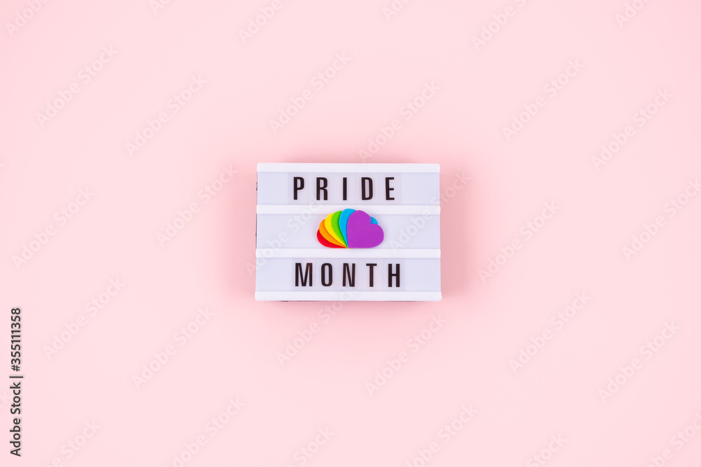 Pride month, LGBT flag symbol concept with Six rainbow color hearts on pink background with text pride month - obrazy, fototapety, plakaty 
