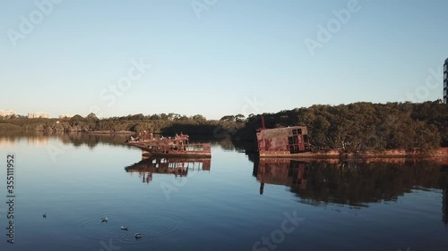 slow drone tracking shot of shipwreck ss ayrfield parramatta river homebush sydney photo