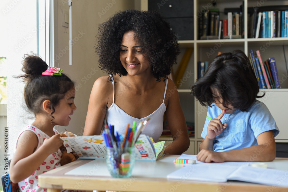 Fototapeta premium Metis mother tutoring her children at home