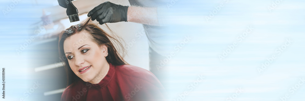 Fototapeta premium Hairdresser coloring hair; panoramic banner