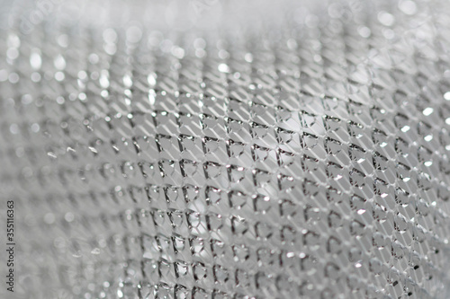 Macro picture of a silver decorative fabric. Silver background.