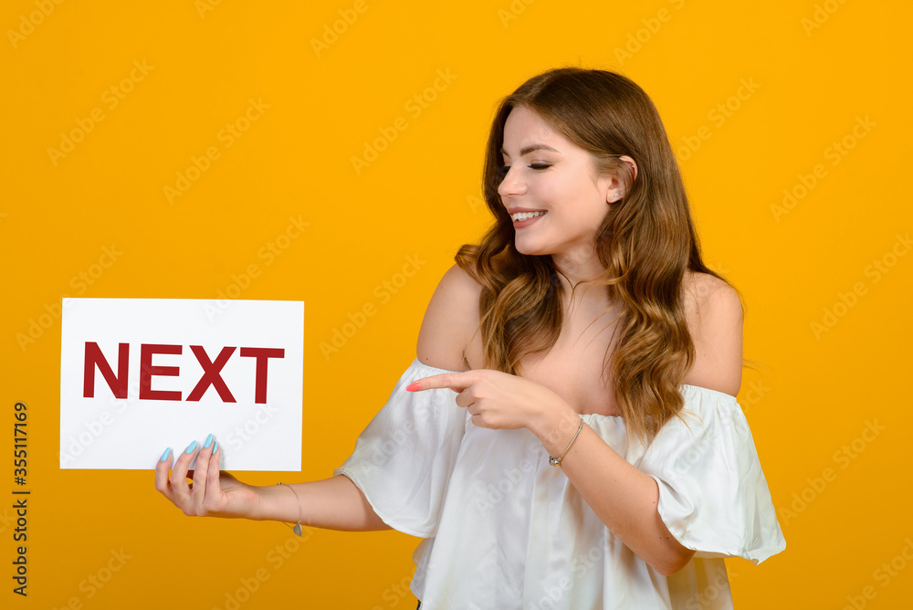 Dark-haired young woman with a smile and big suprised eyes posing on yellow background. Dark-haired young woman with a smile and big suprised eyes posing on yellow background.