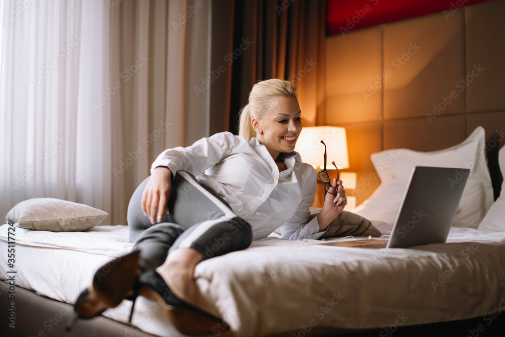 Young businesswoman working on lap top. Beautiful woman working in hotel room. Young businesswoman working on lap top. Beautiful woman working in hotel room.