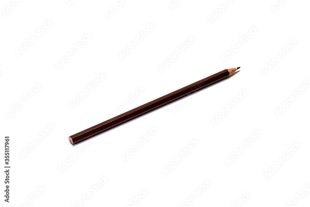 A brown pencil lies diagonally on an isolated white background. Isolate. A brown pencil lies diagonally on an isolated white background. Isolate.