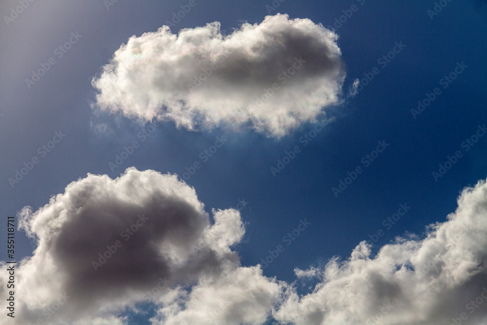 Beautiful puffy clouds in the rays of the sun on a blue sky. Beautiful puffy clouds in the rays of the sun on a blue sky.