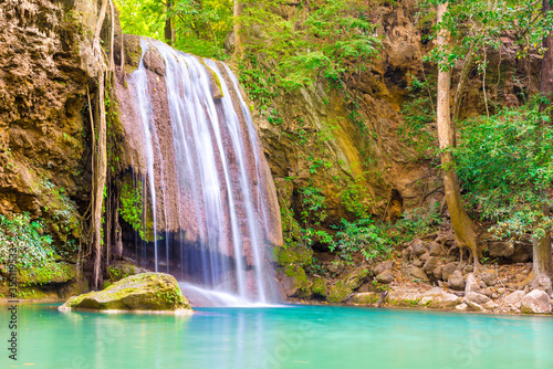 Fototapeta Naklejka Na Ścianę i Meble -  Tropical landscape with beautiful waterfall, wild rainforest with green foliage and flowing water. Erawan National park, Kanchanaburi, Thailand