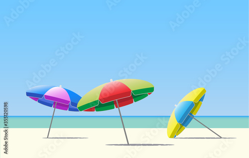 Colorful beach umbrellas / parasol on a sunny beach. 