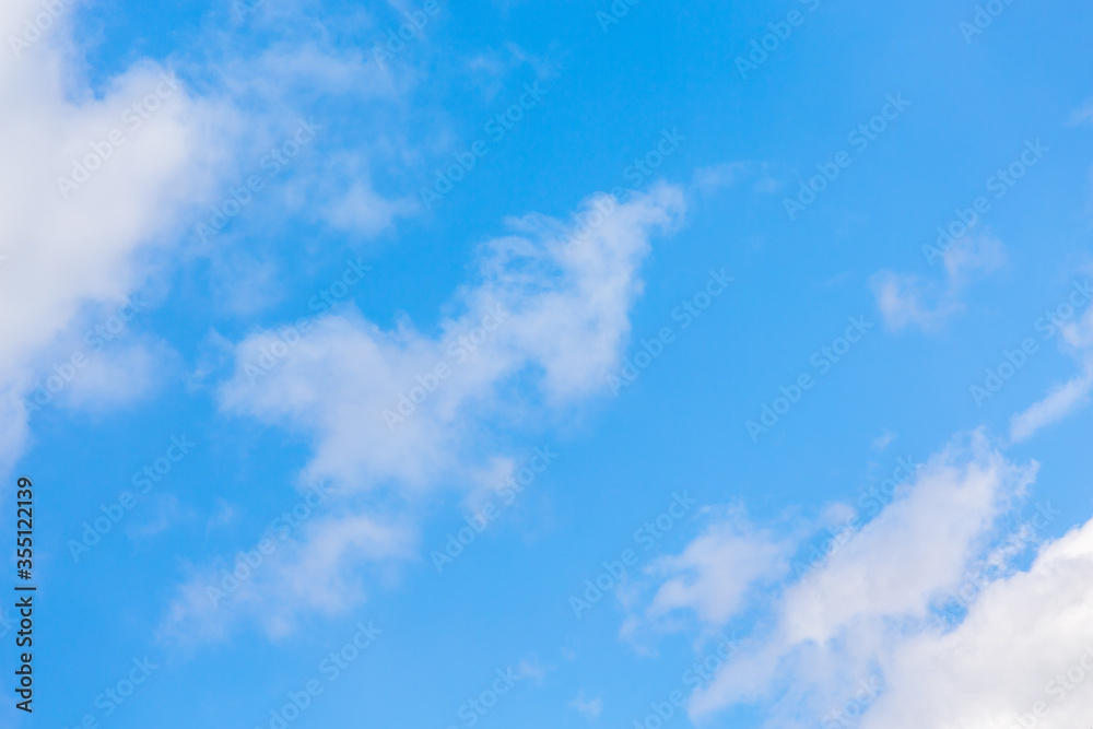 fluffy white clouds against a blue sky fluffy white clouds against a blue sky