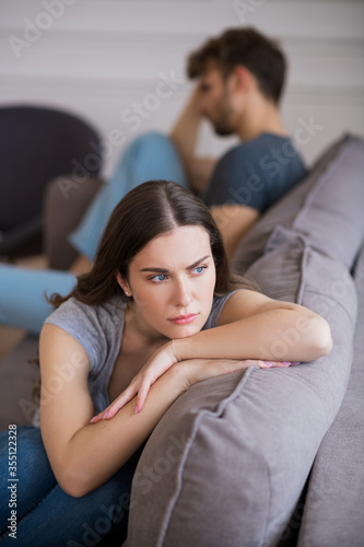 Young woman sitting with a depressed look after a bad talk with her husband